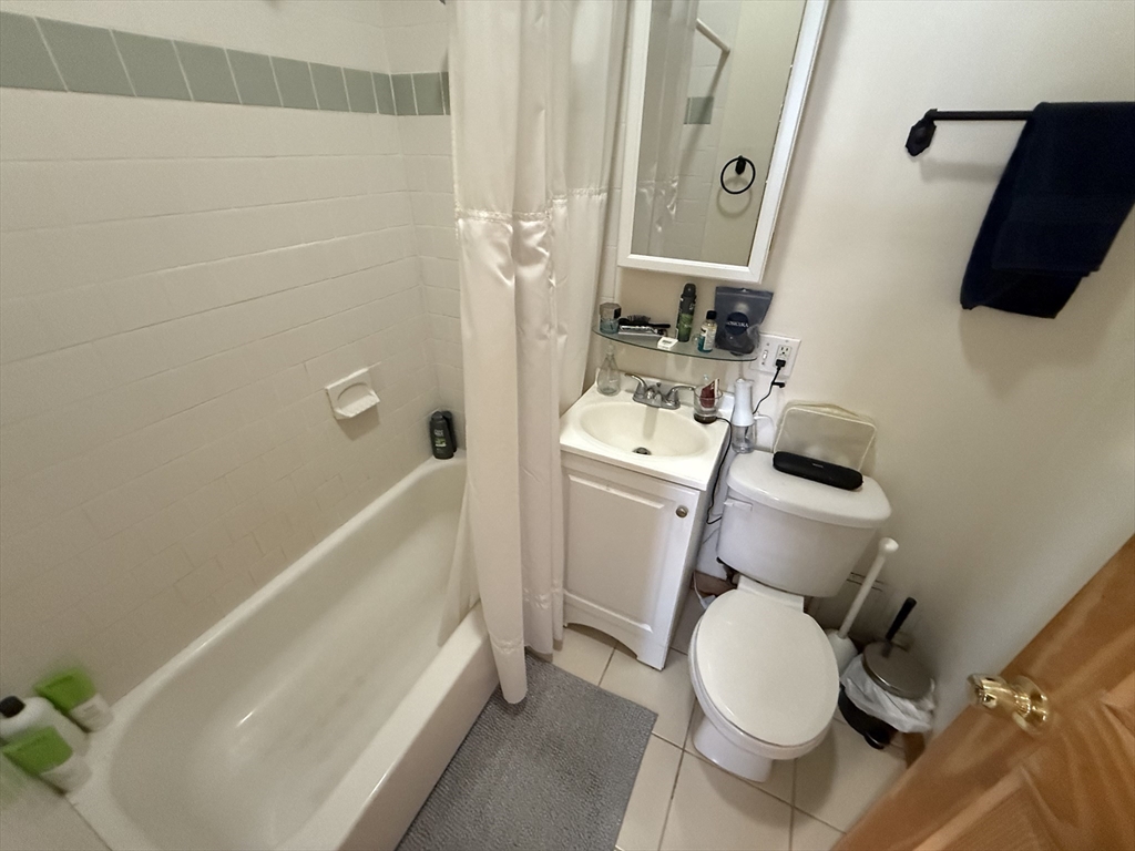 712 Commonwealth Avenue, Unit 1 Boston, MA 02215 - Photo 7 of 7 a bathroom with a sink toilet and shower