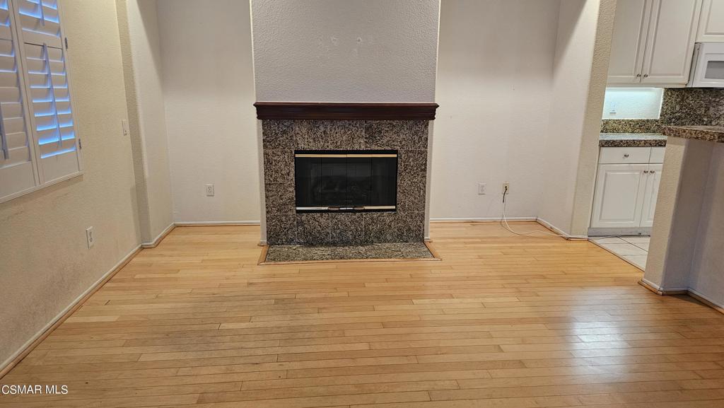 1706 Blazewood Street Simi Valley, CA 93063 - Photo 13 of 13 a view of empty room with wooden floor and fireplace