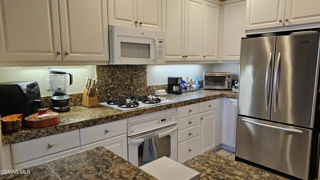 1706 Blazewood Street Simi Valley, CA 93063 - Photo 3 of 13 a kitchen with stainless steel appliances granite countertop a refrigerator sink and stove
