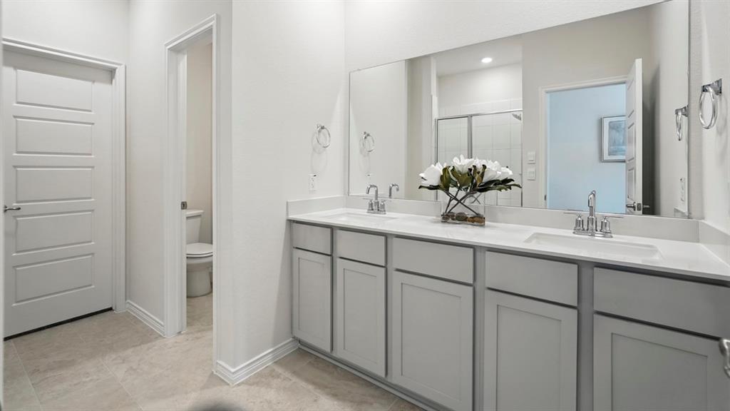 a bathroom with a double vanity sink and mirror