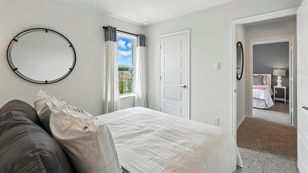 2640 Gladewater Road Celina, TX 75009 - Photo 13 of 40 a bedroom with a bed and a mirror