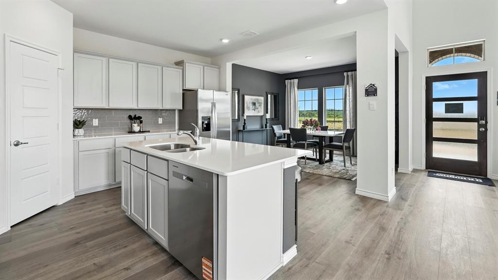 2640 Gladewater Road Celina, TX 75009 - Photo 29 of 40 a kitchen with a sink a counter top space and stainless steel appliances