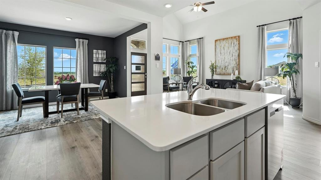 2640 Gladewater Road Celina, TX 75009 - Photo 30 of 40 a kitchen with a sink a table and chairs