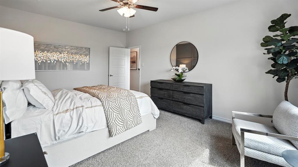 2640 Gladewater Road Celina, TX 75009 - Photo 7 of 40 a bedroom with a bed and a chandelier