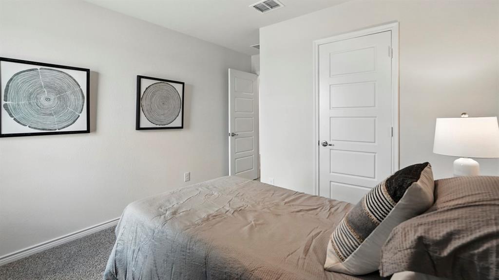 2640 Gladewater Road Celina, TX 75009 - Photo 10 of 40 a bedroom with a bed and painting on the wall