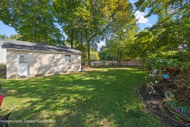 a view of an house with backyard space and garden