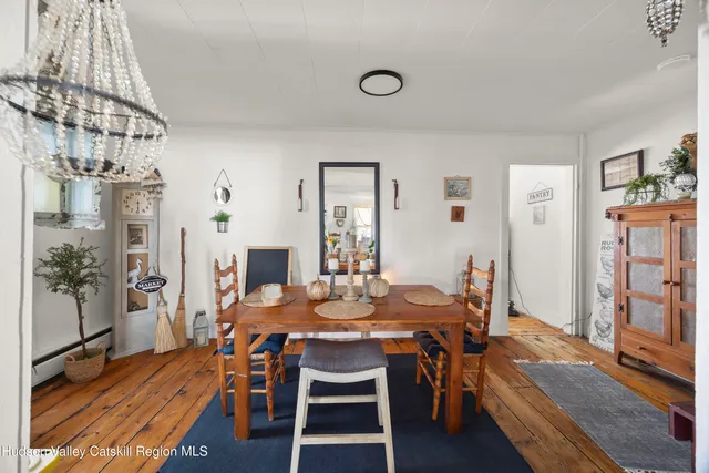 a dining room with furniture and wooden floor