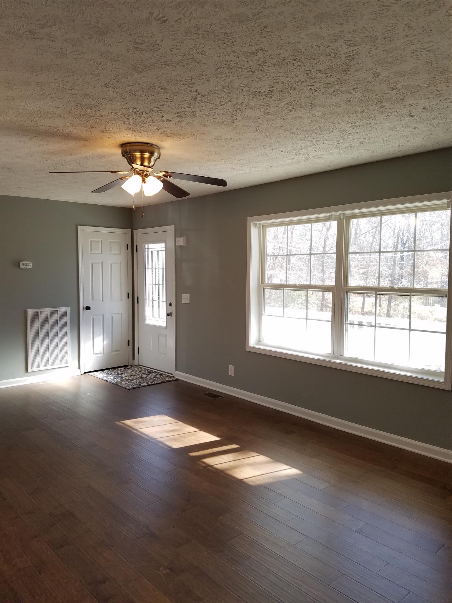 1300 Glendale Road Dickson, TN 37055 - Photo 16 of 30 an empty room with wooden floor and windows