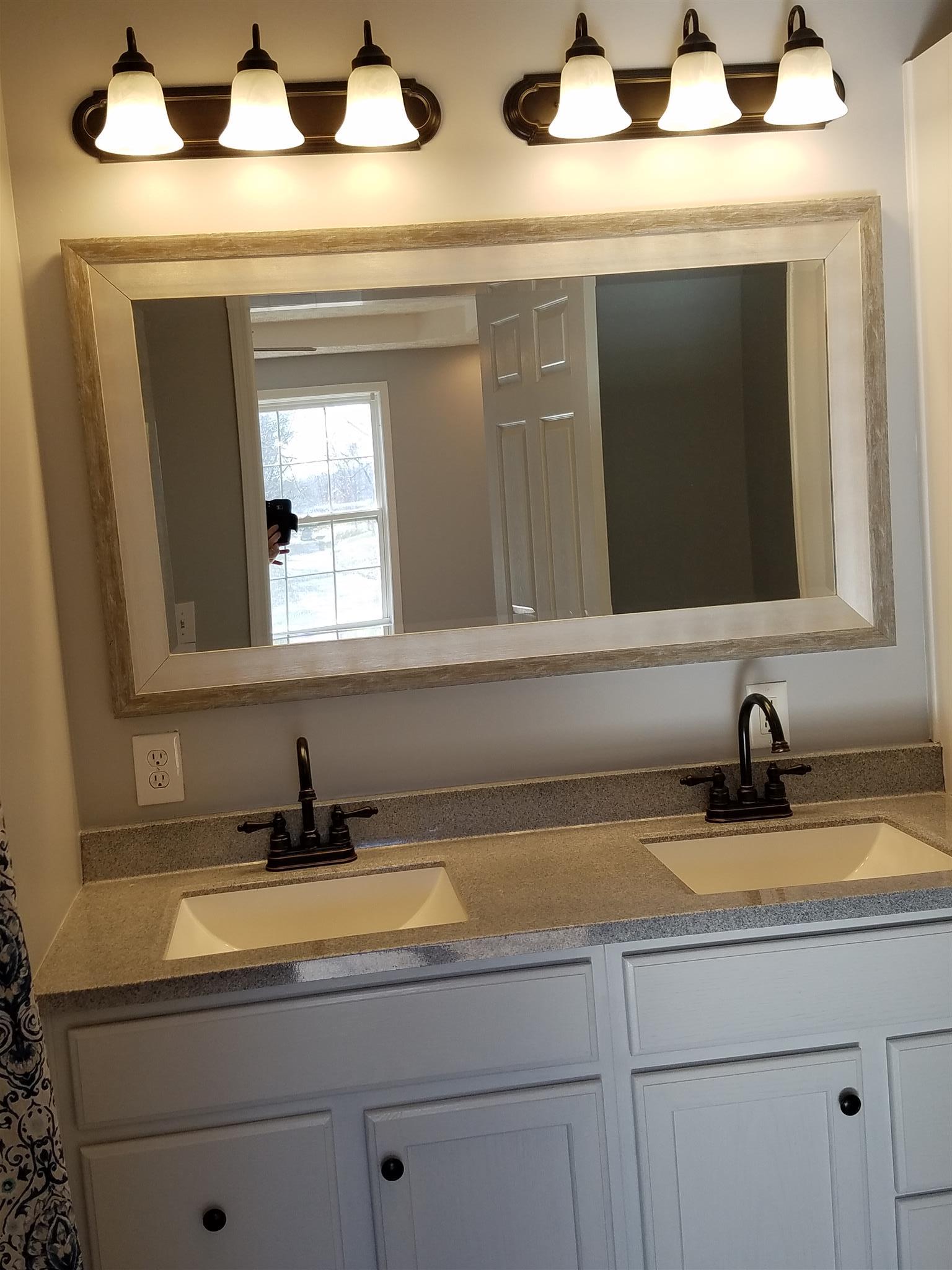1300 Glendale Road Dickson, TN 37055 - Photo 22 of 30 a bathroom with a sink and a mirror