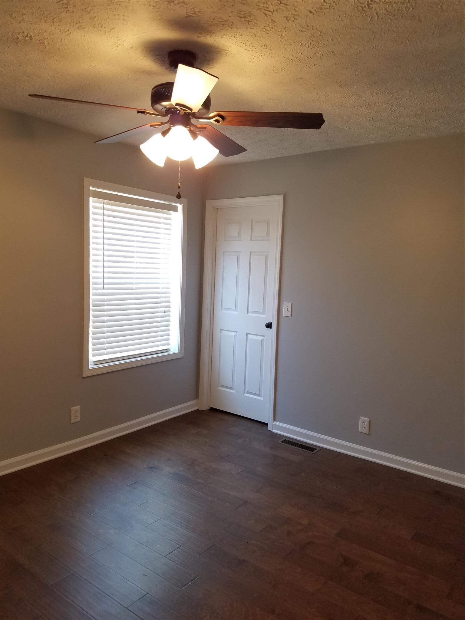 1300 Glendale Road Dickson, TN 37055 - Photo 24 of 30 a view of an empty room with wooden floor and a window