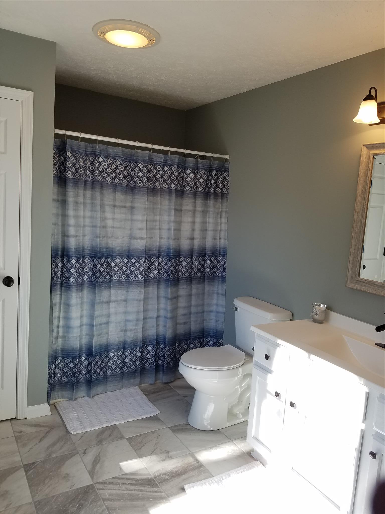 1300 Glendale Road Dickson, TN 37055 - Photo 25 of 30 a bathroom with a sink toilet and shower
