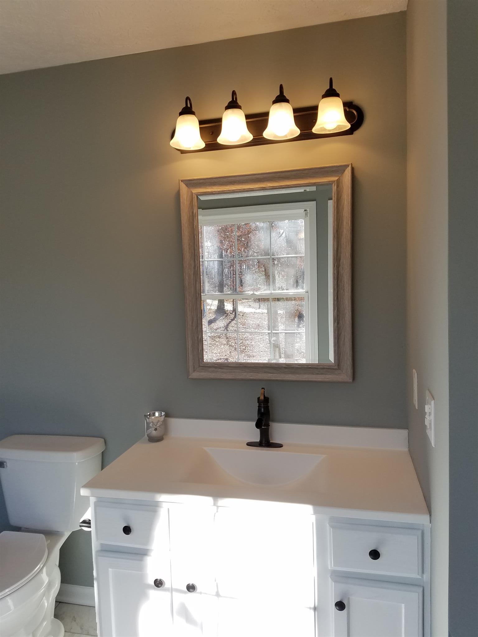 1300 Glendale Road Dickson, TN 37055 - Photo 26 of 30 a bathroom with a sink and a mirror