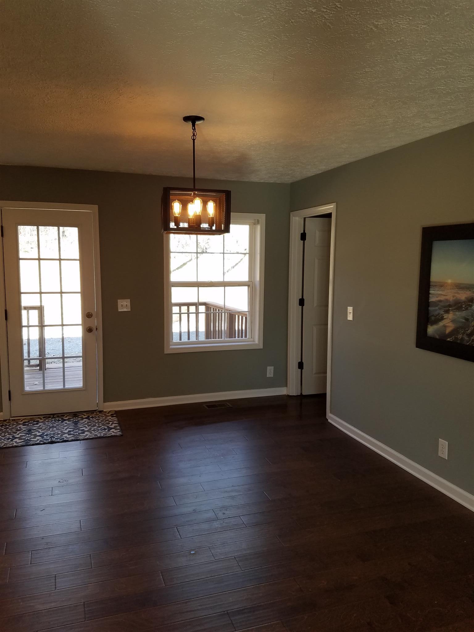 1300 Glendale Road Dickson, TN 37055 - Photo 10 of 30 a view of an empty room with wooden floor and a window