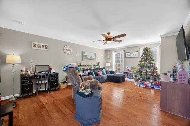 a living room with furniture kitchen view and a large window