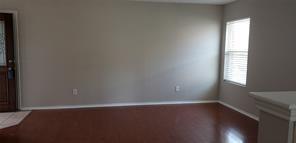 9004 Quarry Ridge Trail Fort Worth, TX 76244 - Photo 10 of 11 an empty room with wooden floor and windows with curtains