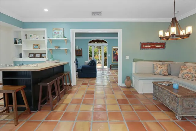 a living room with a couch and a chandelier