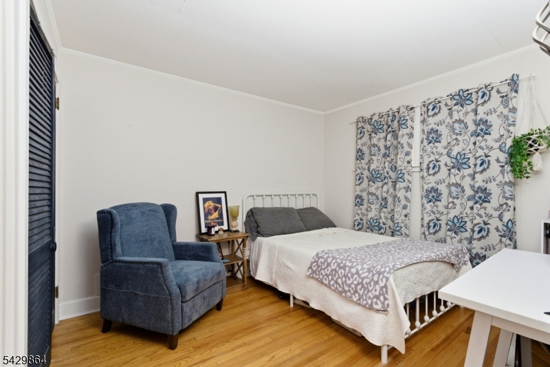 77 Lower North Shore Road Branchville, NJ 07826 - Photo 18 of 38 a bedroom with a bed couch and a window