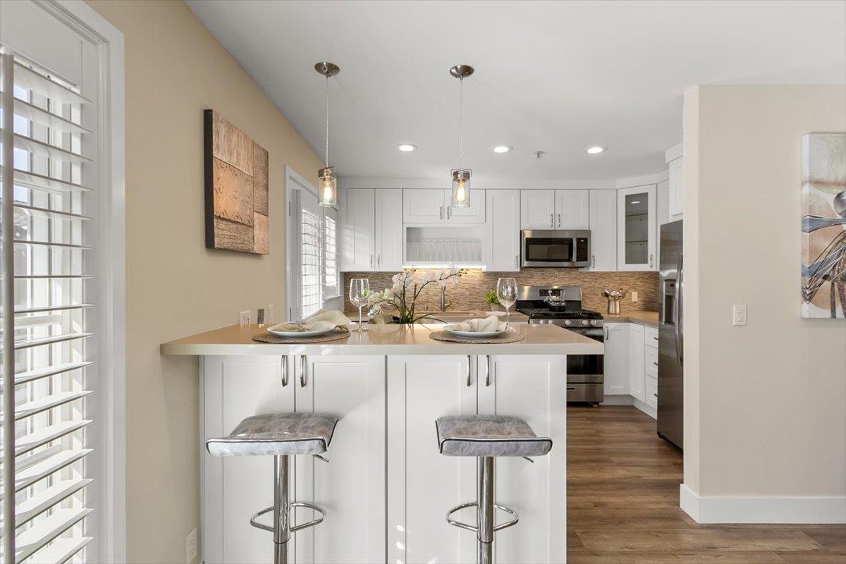 654 North San Antonio Road Los Altos, CA 94022 - Photo 22 of 28 a kitchen with stainless steel appliances kitchen island granite countertop a stove top oven a sink and a refrigerator