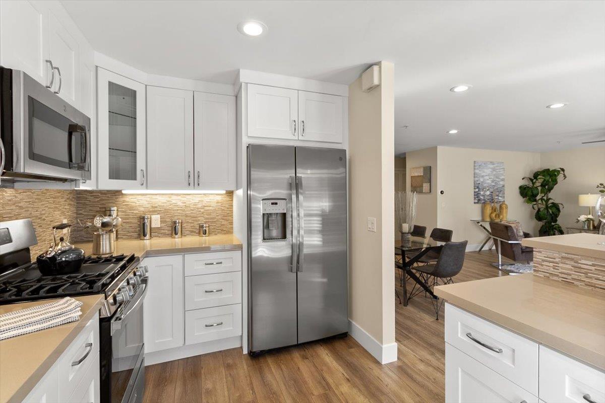 654 North San Antonio Road Los Altos, CA 94022 - Photo 23 of 28 a kitchen with white cabinets and stainless steel appliances