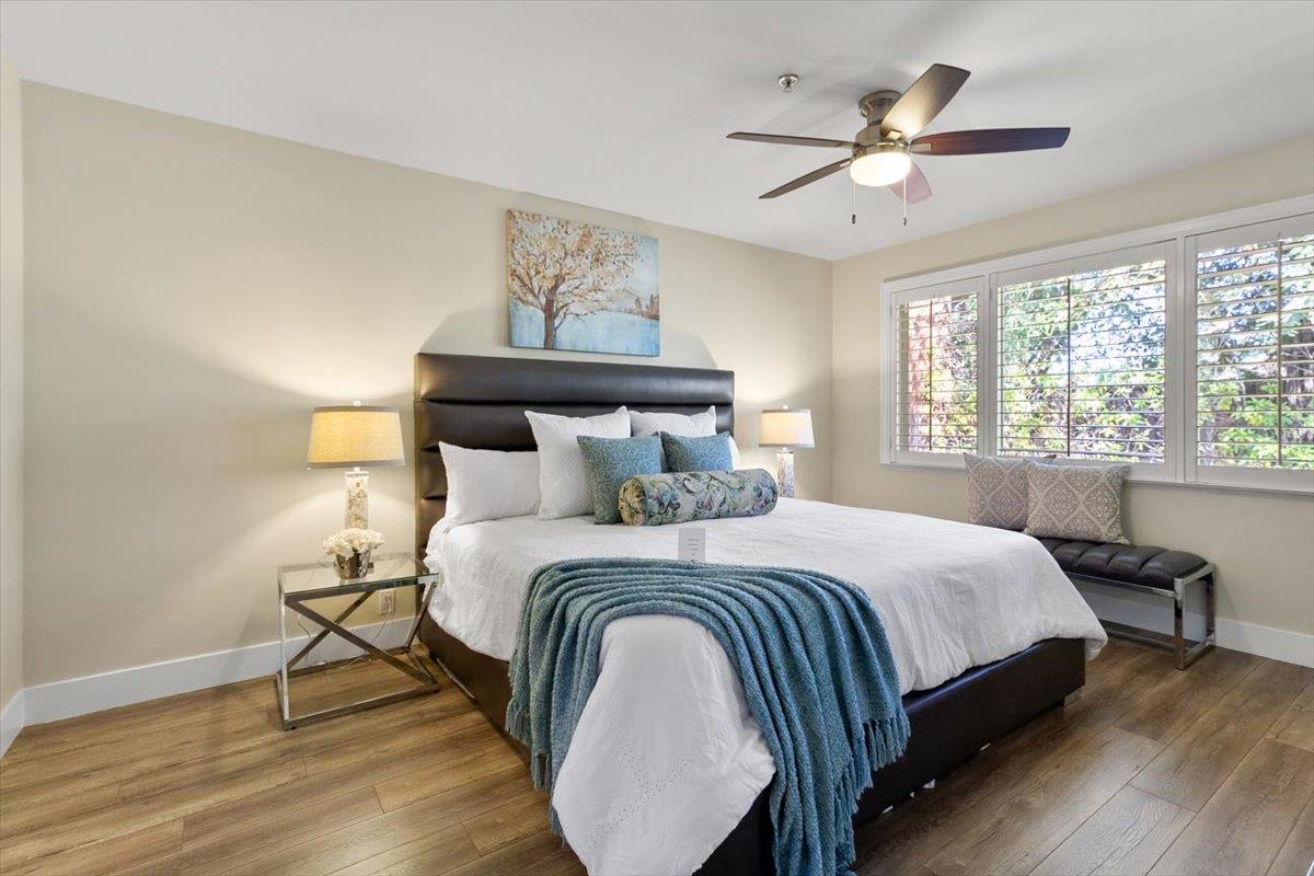 654 North San Antonio Road Los Altos, CA 94022 - Photo 7 of 28 a bedroom with a bed and a chandelier