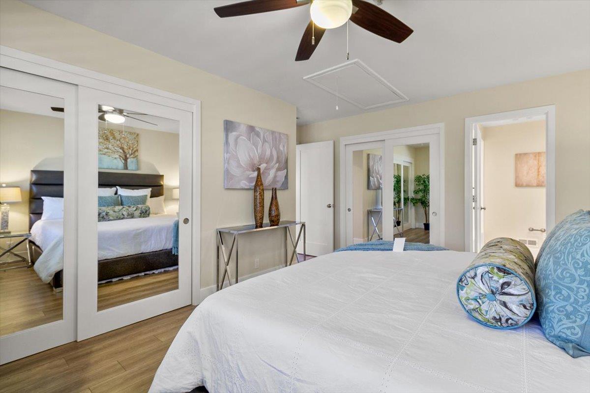 654 North San Antonio Road Los Altos, CA 94022 - Photo 8 of 28 a bedroom with a bed and a chandelier