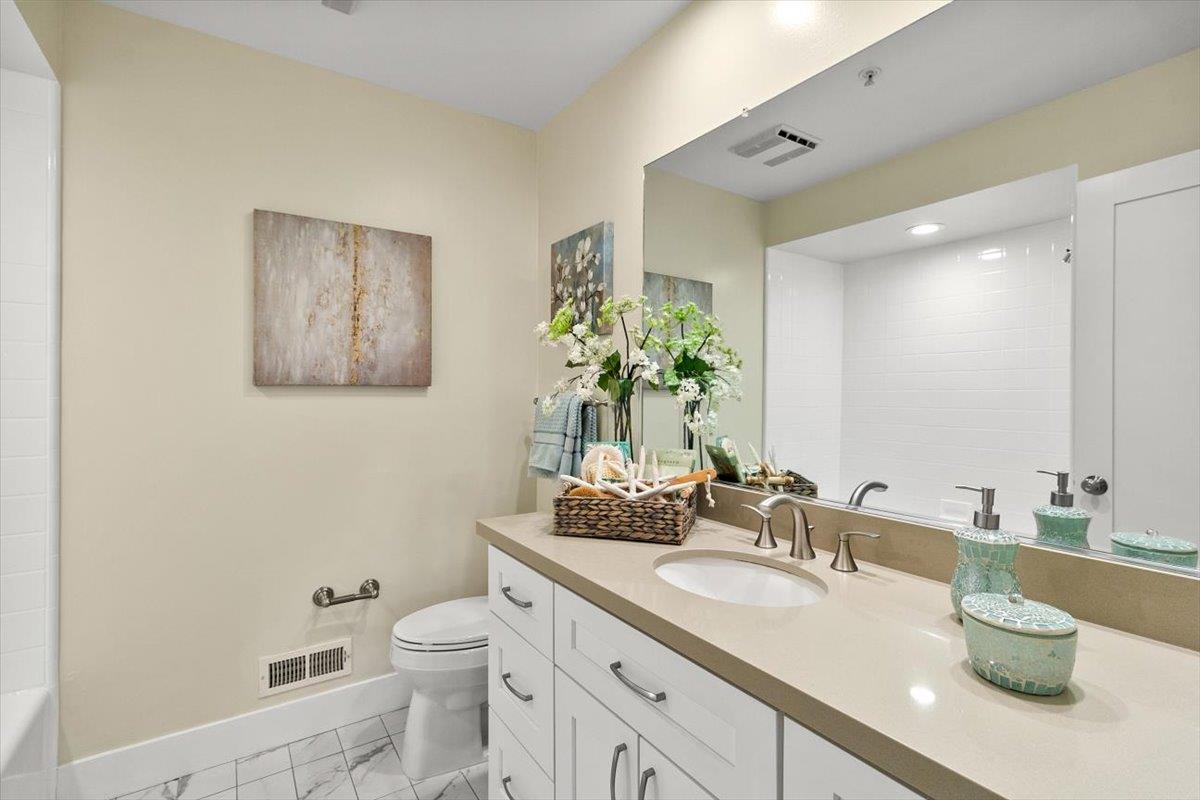 654 North San Antonio Road Los Altos, CA 94022 - Photo 9 of 28 a bathroom with a granite countertop sink mirror and toilet