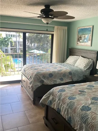 a bedroom with a large bed and a large window