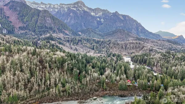a view of a house with a mountain and a forest