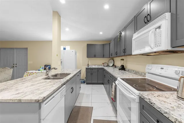 a kitchen with a sink stove and cabinets