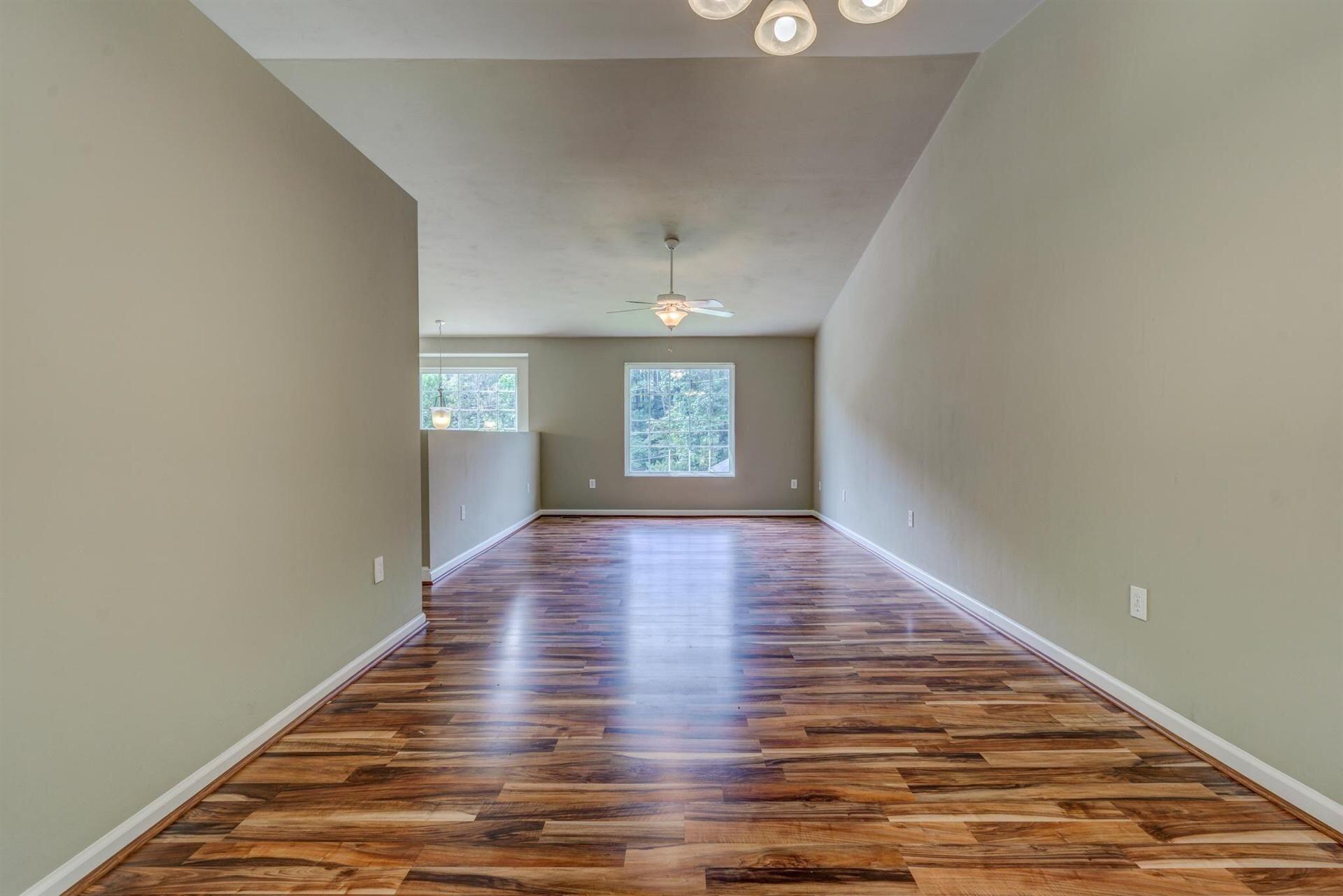 4231 Daugherty Road Salem, VA 24153 - Photo 4 of 23 a view of an empty room with window and wooden floor