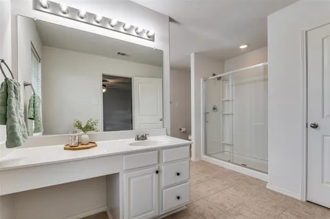 a bathroom with a double vanity sink and a mirror