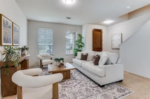 a living room with furniture and a potted plant