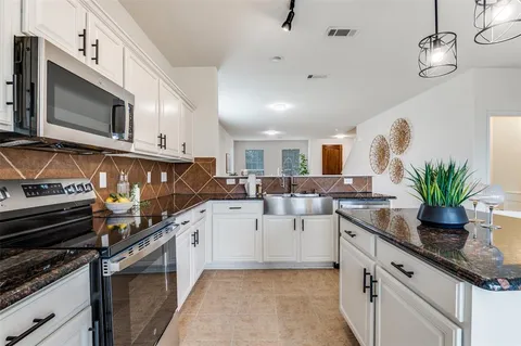 a kitchen with a sink stove and microwave