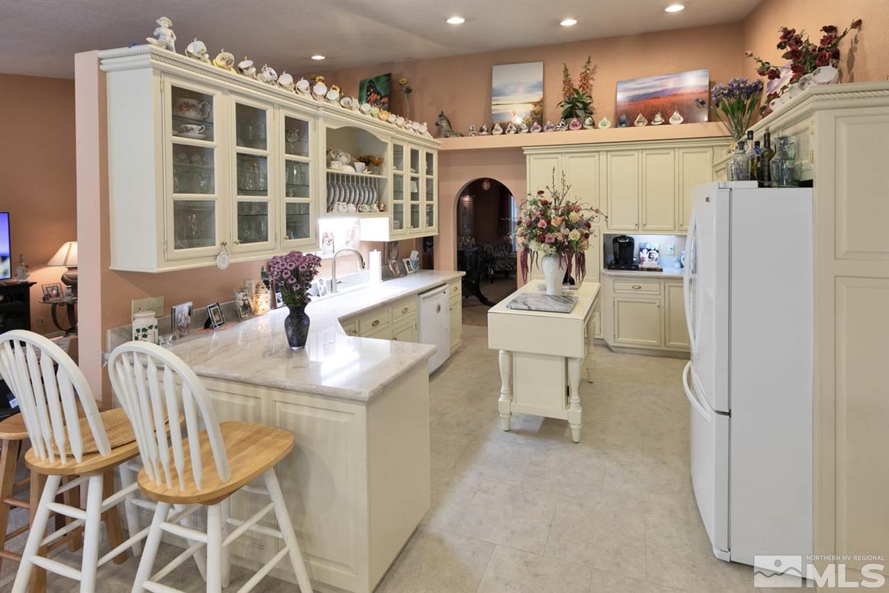 5721 Rivers Edge Drive Fallon, NV 89406 - Photo 5 of 17 a kitchen with a sink a refrigerator and cabinets