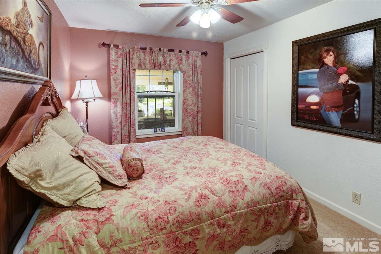 5721 Rivers Edge Drive Fallon, NV 89406 - Photo 6 of 17 a bedroom with a bed and a painting on the wall