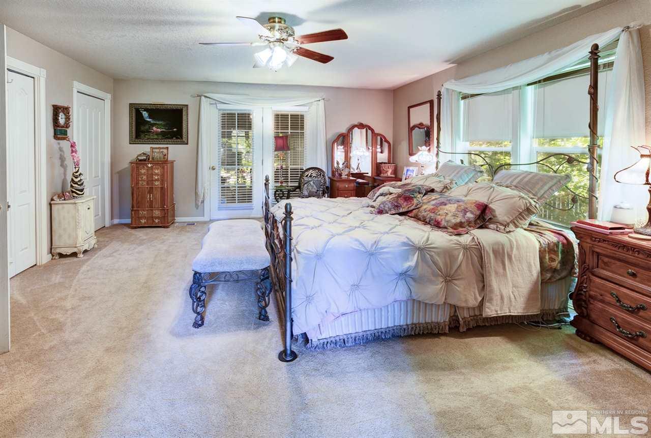 5721 Rivers Edge Drive Fallon, NV 89406 - Photo 8 of 17 a bedroom with a bed and a chandelier