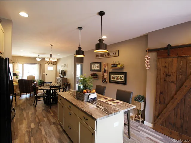 a kitchen with stainless steel appliances granite countertop sink stove and wooden floor
