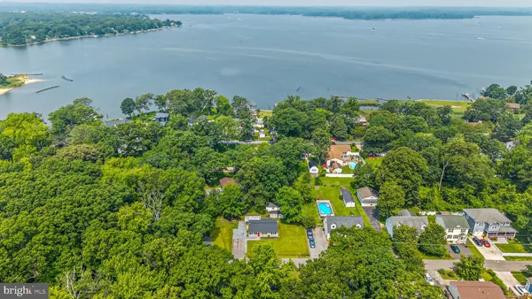 a backyard of a house with lots of green space and lake view