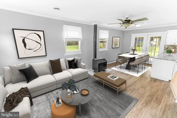 a living room with furniture and wooden floor