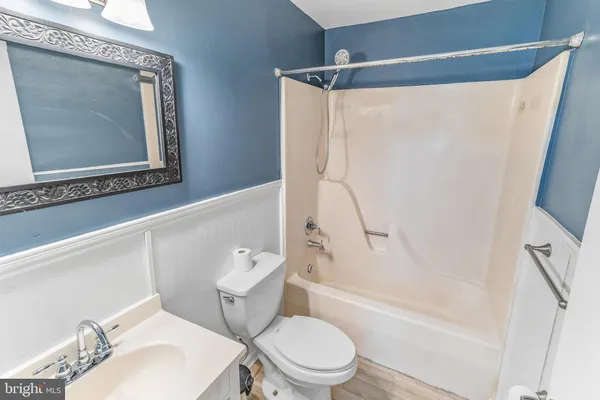 a white toilet sitting next to a bath tub shower
