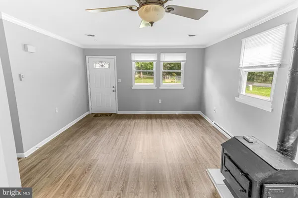 a kitchen with a sink and wooden floor