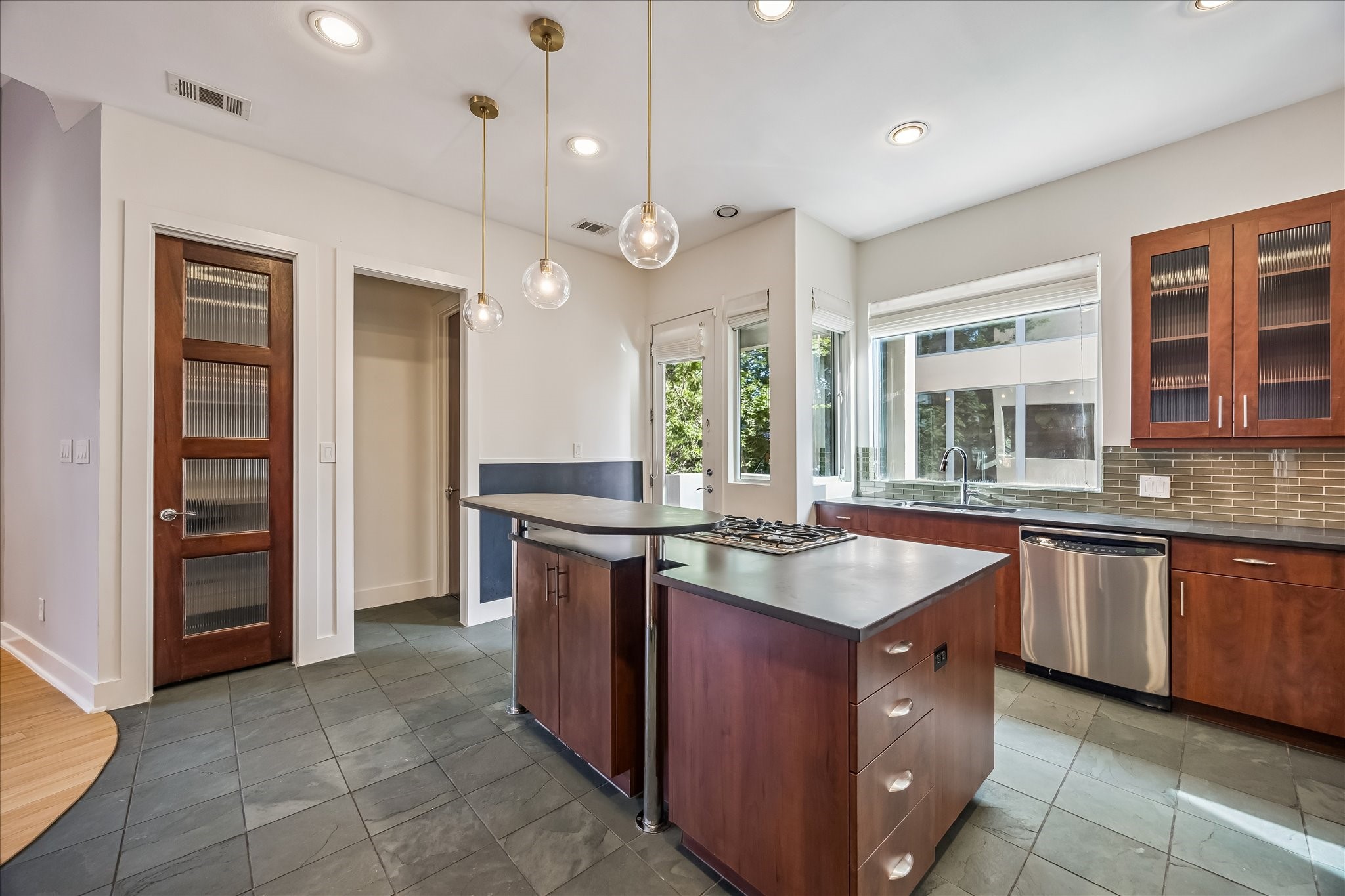 1610 Calumet Street Houston, TX 77004 - Photo 11 of 36 a kitchen with granite countertop cabinets a sink a island and windows in it