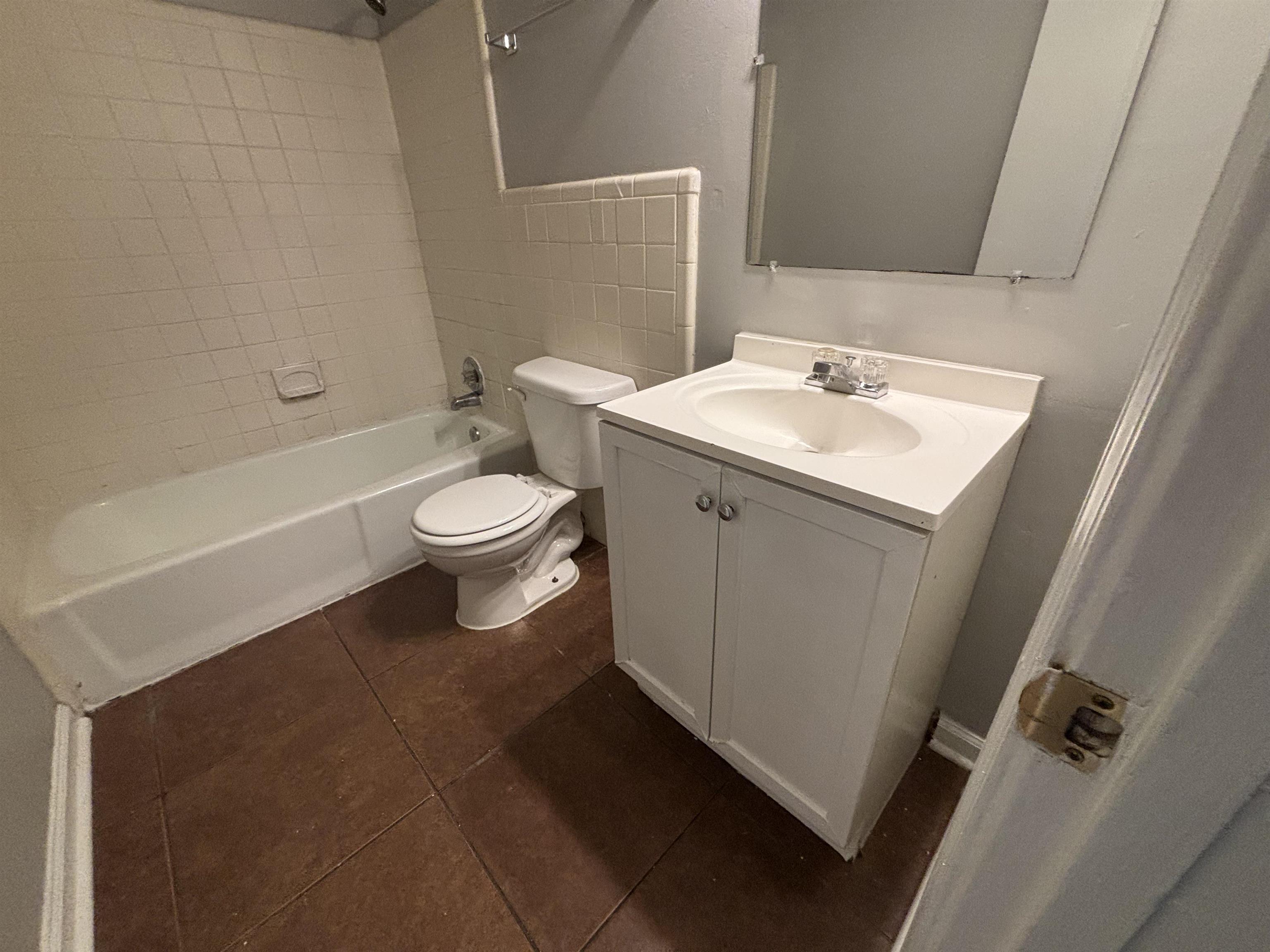 4040 Windermere Road Memphis, TN 38128 - Photo 11 of 14 Full bath with vanity, dark tile patterned flooring, and shower / washtub combination