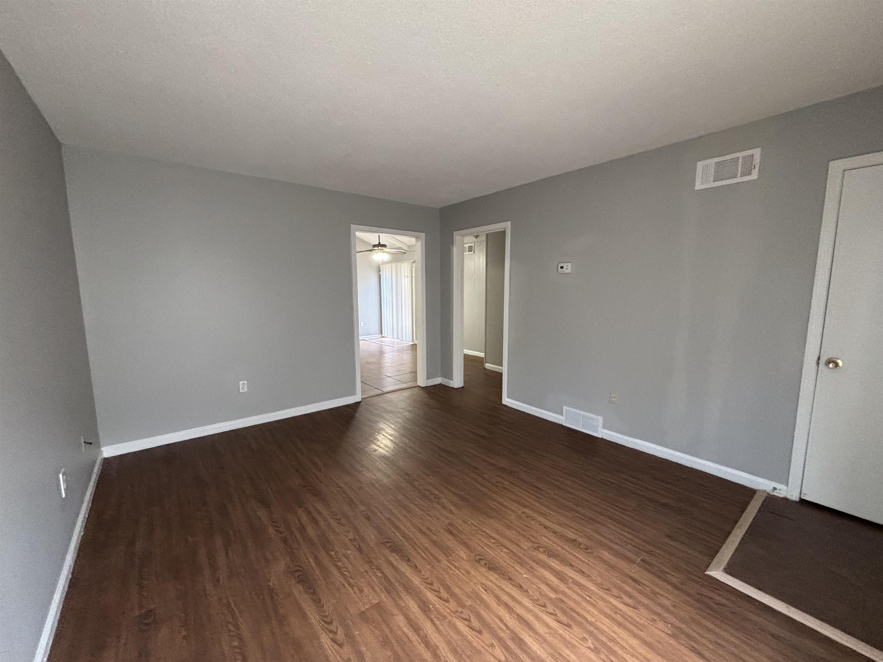 4040 Windermere Road Memphis, TN 38128 - Photo 4 of 14 Spare room with dark wood finished floors, a ceiling fan, and a textured ceiling