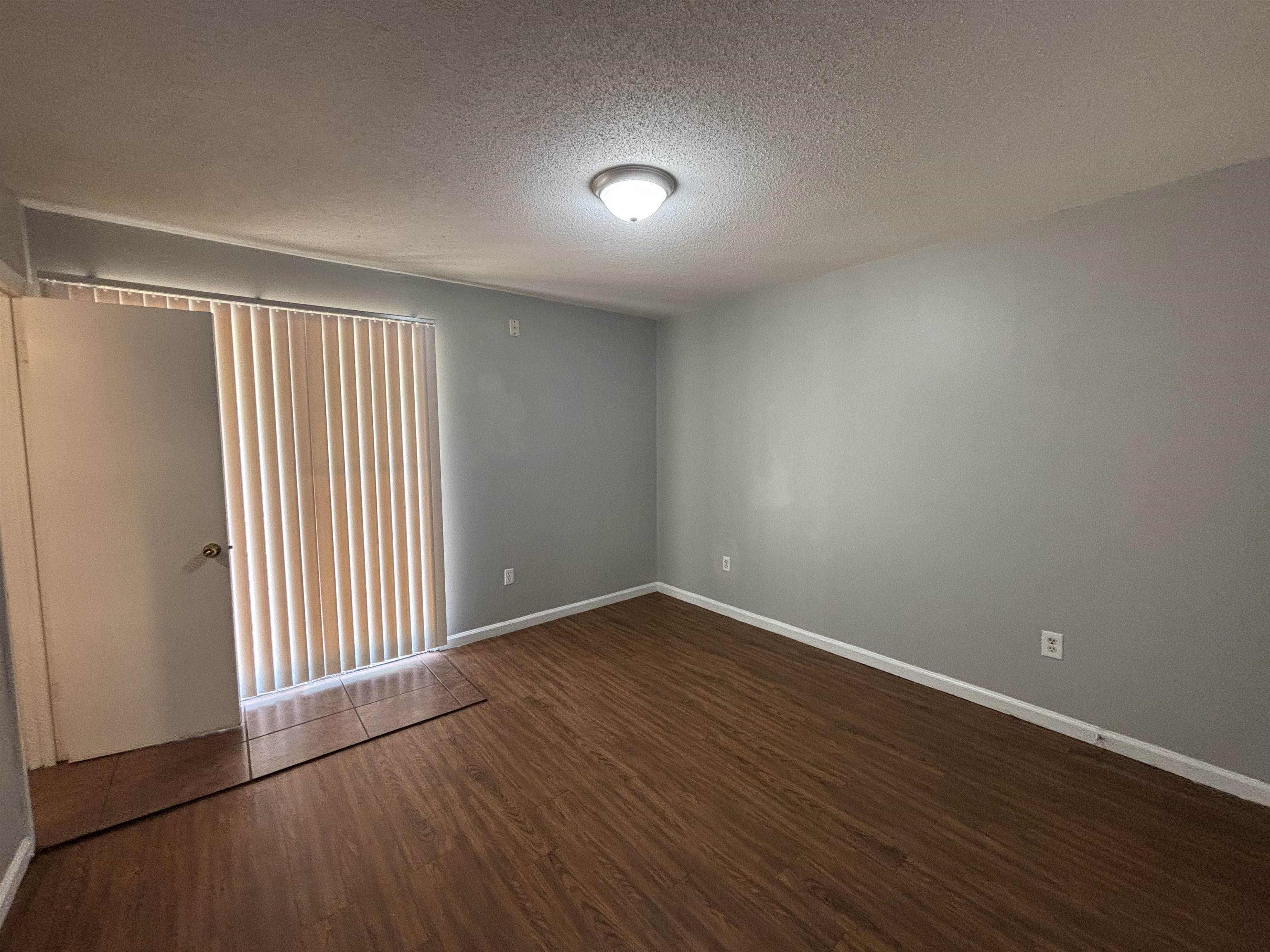 4040 Windermere Road Memphis, TN 38128 - Photo 9 of 14 Unfurnished room featuring a textured ceiling and dark wood finished floors