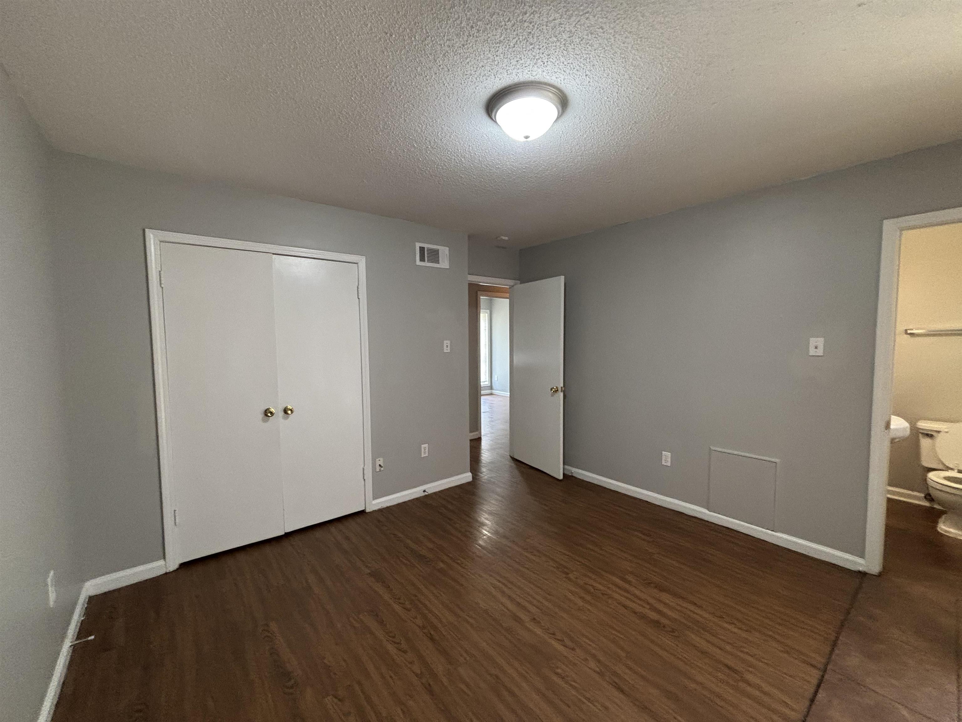 4040 Windermere Road Memphis, TN 38128 - Photo 10 of 14 Unfurnished bedroom with a textured ceiling, dark wood finished floors, and a closet
