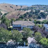 an aerial view of house with a garden