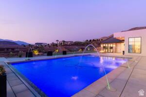 1141 East Lost Ridge Drive Washington, UT 84780 - Photo 14 of 108 Outdoor swimming pool with integrated water features, surrounded by a light-toned paved patio