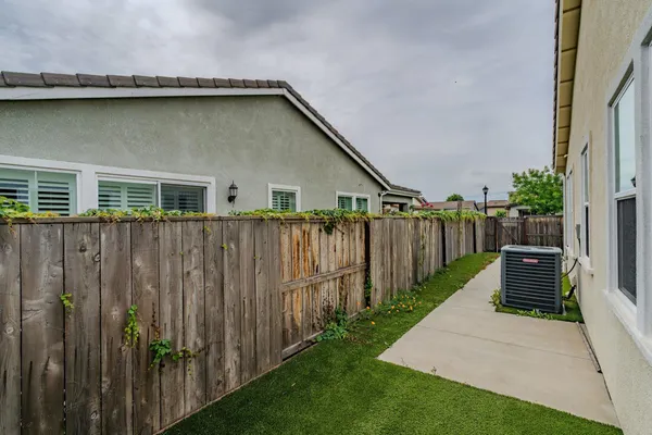an aerial view of a house with garden space and street view