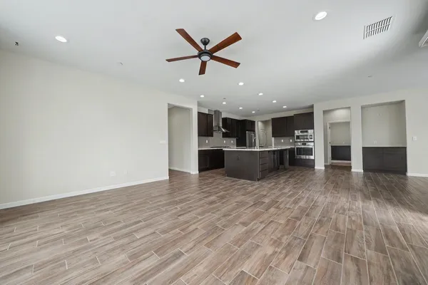 a kitchen with kitchen island granite countertop a sink stove and refrigerator